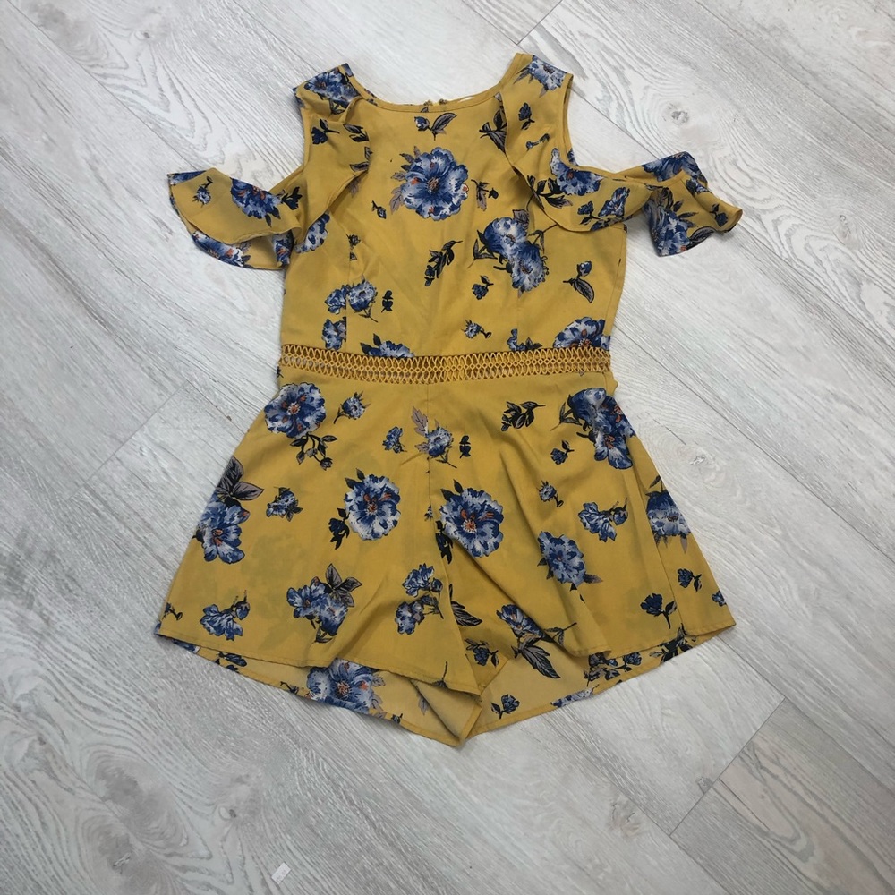 A floral romper with ruffle sleeves and a space